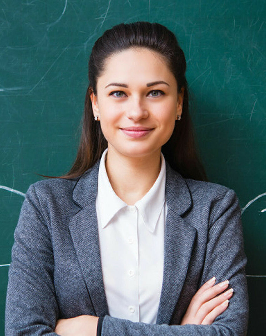 Female professorin in front of blackboard, drawing showing flexed muscled arms in background; Brain City Berlin 