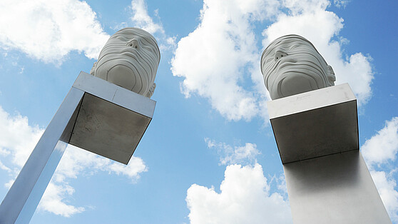  The two stone heads in front of the Forum Adlershof from below, Brain City Berlin 